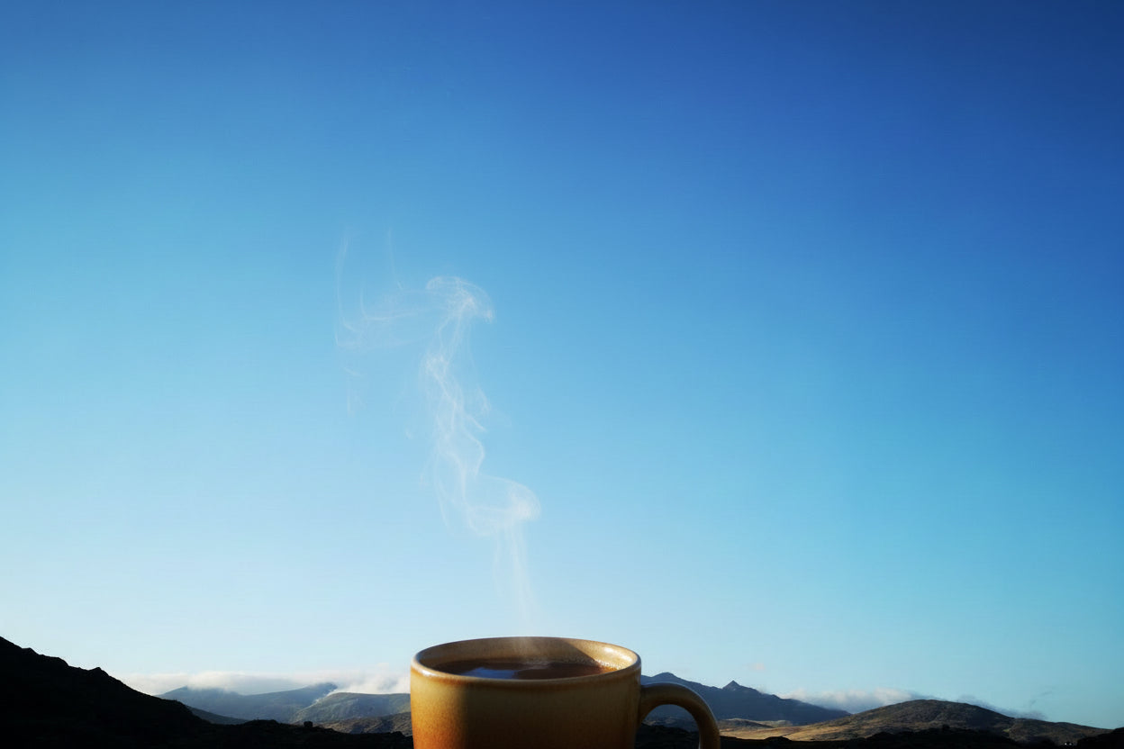 Silhouette of mountains against a clear blue sky
